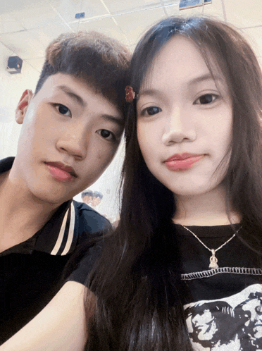 a boy and a girl are posing for a picture and the girl is wearing a shirt that says ' i love you '