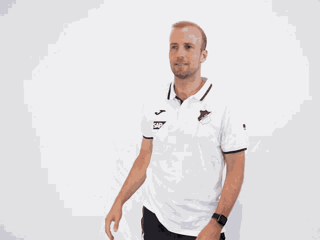 a man wearing a white shirt that says sap on the front