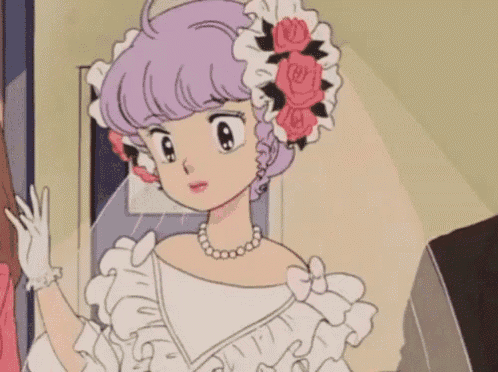 a woman in a white dress with flowers in her hair