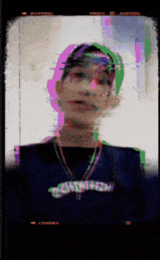 a blurry picture of a person with a necklace that says anthem on it