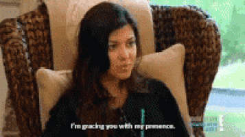 a woman is sitting in a chair and saying i 'm grateful you with my presence