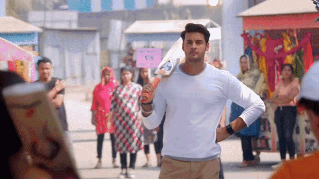 a man holding a bat with a sign that says ' cricket vs '