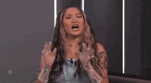 a woman with long hair is wearing clear plastic gloves while talking on a television show .