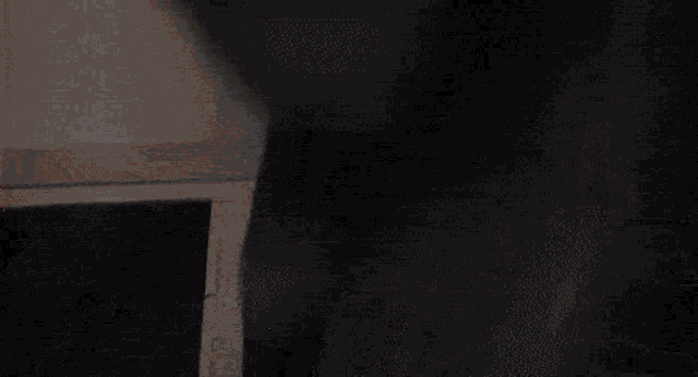 a person is laying on a bed in a room with a white ceiling .