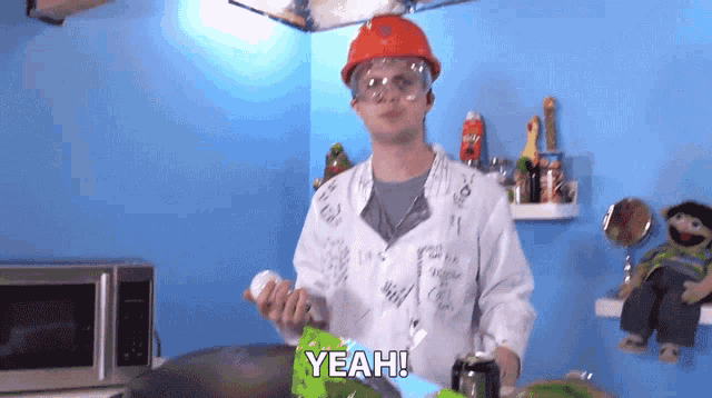 a man wearing a hard hat and goggles says yeah in a kitchen