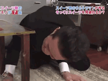 a man is crawling on the floor in front of a sign that says ' s ' on it