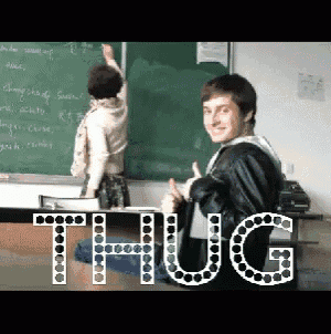 a man is giving a thumbs up in front of a blackboard with the word thug on it