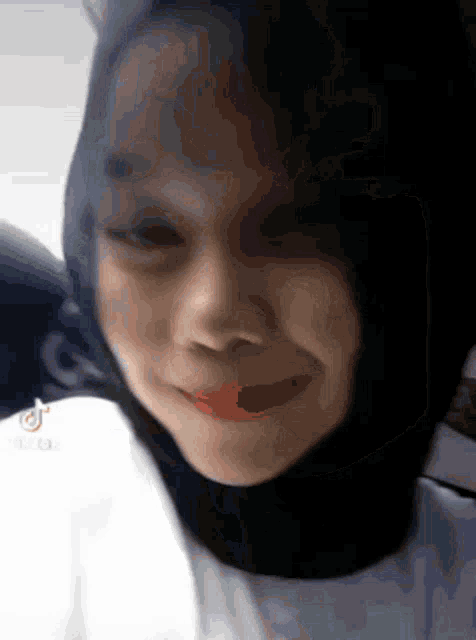 a close up of a woman wearing a hijab