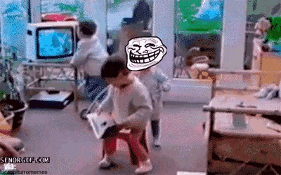 a group of children are playing a video game with a troll face in the background .
