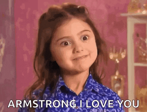 a little girl in a blue shirt is making a face and saying `` armstrong , i love you '' .