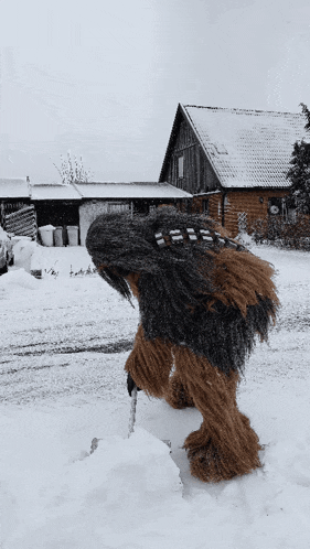 a person dressed as chewbacca is walking through the snow