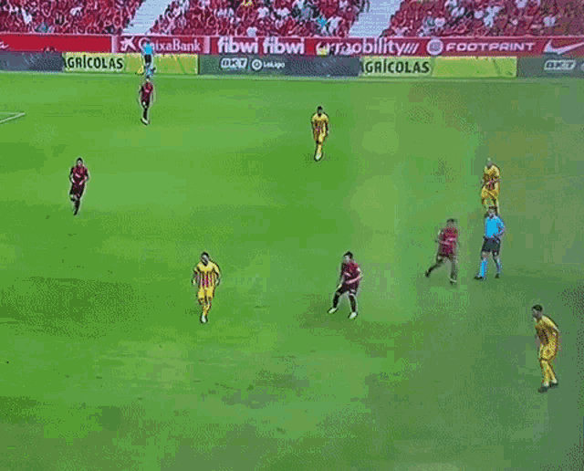 a soccer game is being played on a field with advertisements for nike and estrella