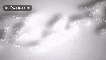 a black and white photo of a person 's face with a light coming out of it