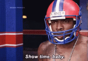 a shirtless man wearing a football helmet says " show time baby "