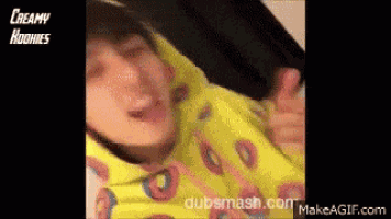 a person wearing a yellow hoodie with donuts on it