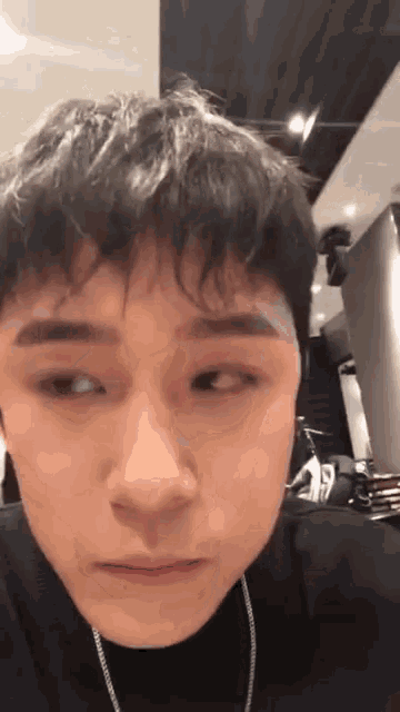 a close up of a young man 's face with his eyes closed