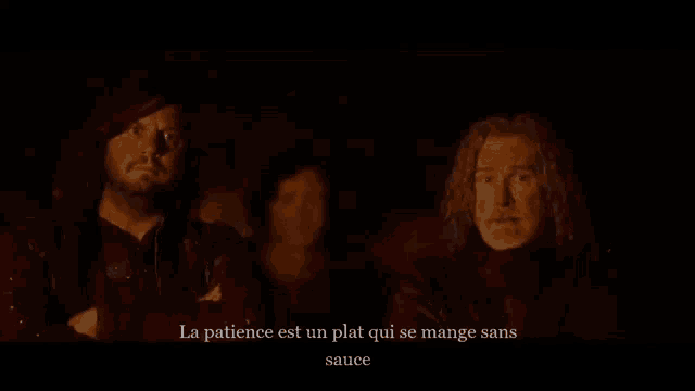 three men are standing in a dark room with the words la patience est un plat qui se mange sans sauce written above them