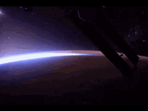 a view of the earth from space with a blue light