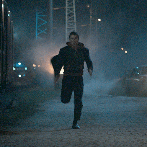 a man running in front of a sign that says ' max '