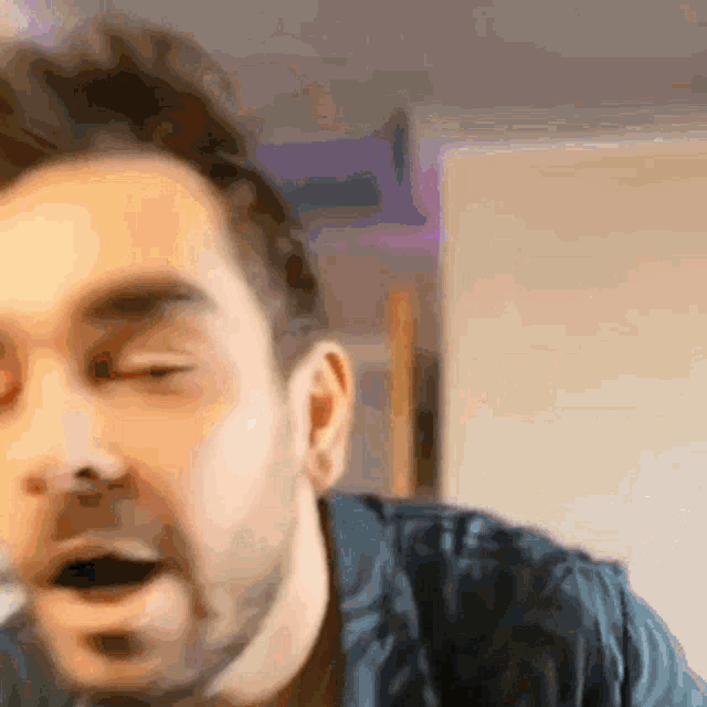a close up of a man 's face with his eyes closed .