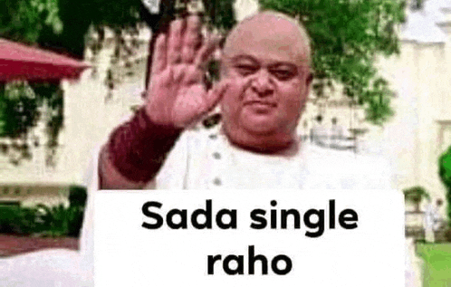 a bald man is waving at the camera while holding a sign that says sada single raho .