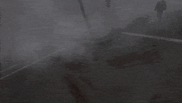a truck is driving through a foggy parking lot