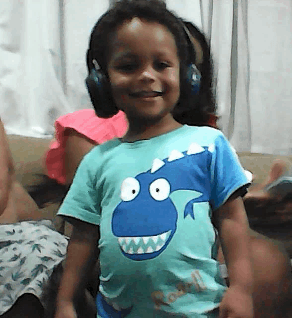 a little boy wearing headphones and a shirt that says real