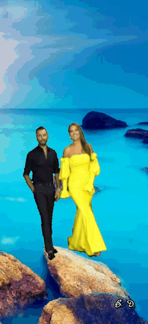 a man and a woman are standing on a rock in front of the ocean