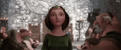 a woman in a green dress is standing in front of a group of people in a room .