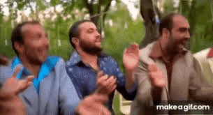 a group of men are standing next to each other and applauding .
