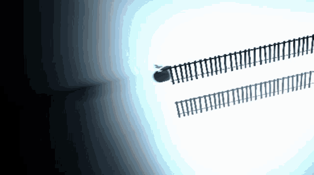 a shadow of a fence on a white wall