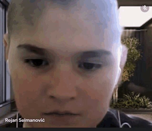 a close up of a person 's face with the name rejan selmanovic on the bottom right