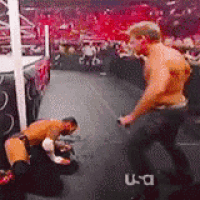 two men are wrestling in a ring with a u-a logo in the background