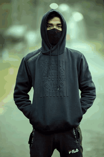 a man wearing a black hoodie that says brooklyn usa