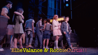a group of people standing on a stage with the words ellie valance and robbie curtis on the bottom