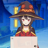 a girl in a witch hat is holding a box with the number 16 on it