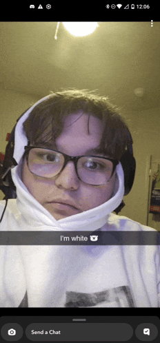 a man wearing glasses and a white hoodie says " i 'm white " on a snapchat