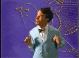 a man in a suit stands in front of a drawing of a bird on a purple background