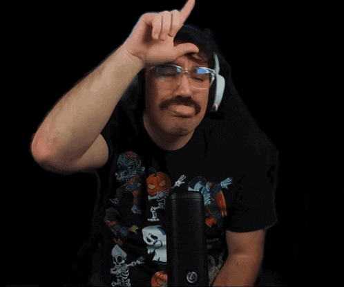 a man with a mustache and glasses is wearing headphones
