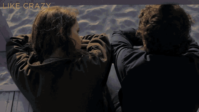 a man and a woman are looking at each other with the words like crazy behind them