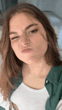a woman with freckles on her face makes a funny face