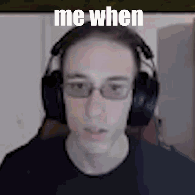 a blurry picture of a man wearing headphones with the caption " me when "