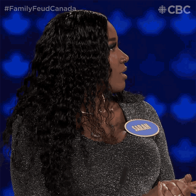 a woman wearing a name tag that says sarah on it