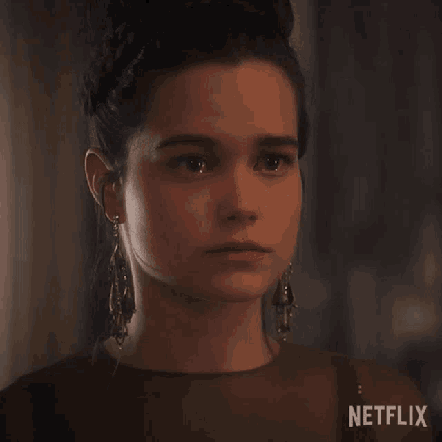 a close up of a woman 's face with the word netflix on the bottom right
