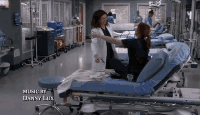 a woman in a hospital bed with the words music by danny lux