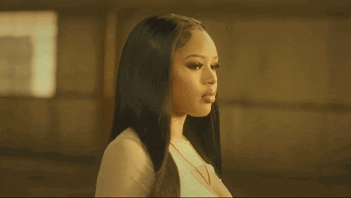 a woman with long black hair is wearing a white shirt