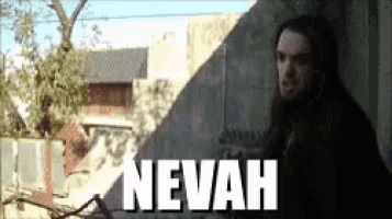 a man leaning against a wall with the word nevah on the bottom