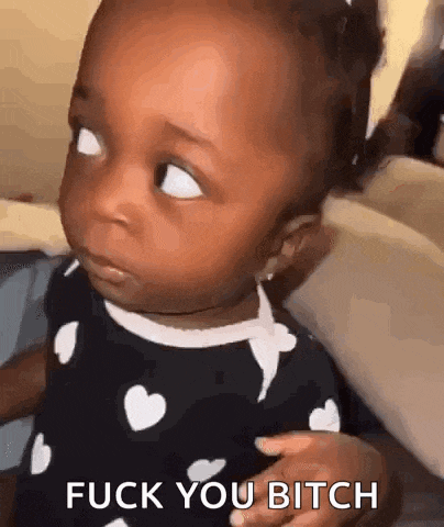 a baby is sitting on a couch and making a funny face .
