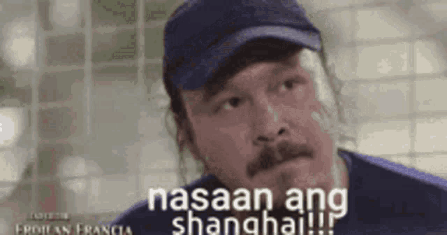a man wearing a baseball cap and a blue shirt says nasaan ang shanghai !!