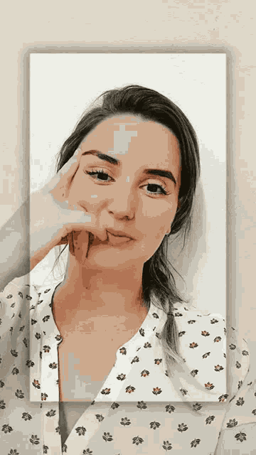 a woman in a white shirt with flowers on it